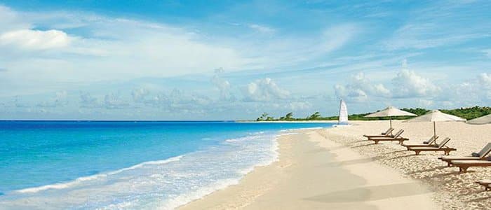 Secrets Maroma includes white sandy beaches and blue waters