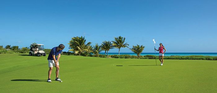 golf greens fees included on a Greg Norman course